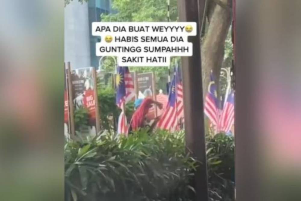 The 37-second video which went viral on TikTok, shows a man in a red shirt and a blue cap cutting several Jalur Gemilang installed on the footpath.
