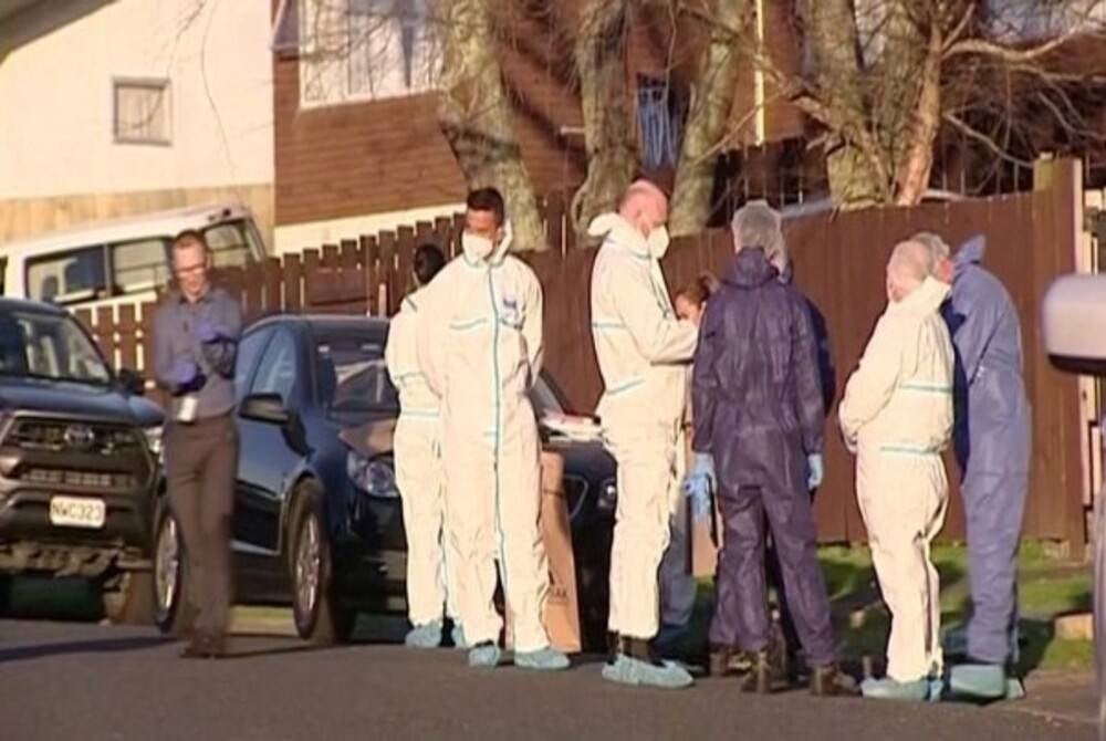 Police and forensic investigators at the scene where suitcases with remains of two children were found, after a family, who are not connected to the deaths, bought them at an online auction in Auckland, New Zealand last Aug 11, 2022 - Still image taken from a video from Reuters