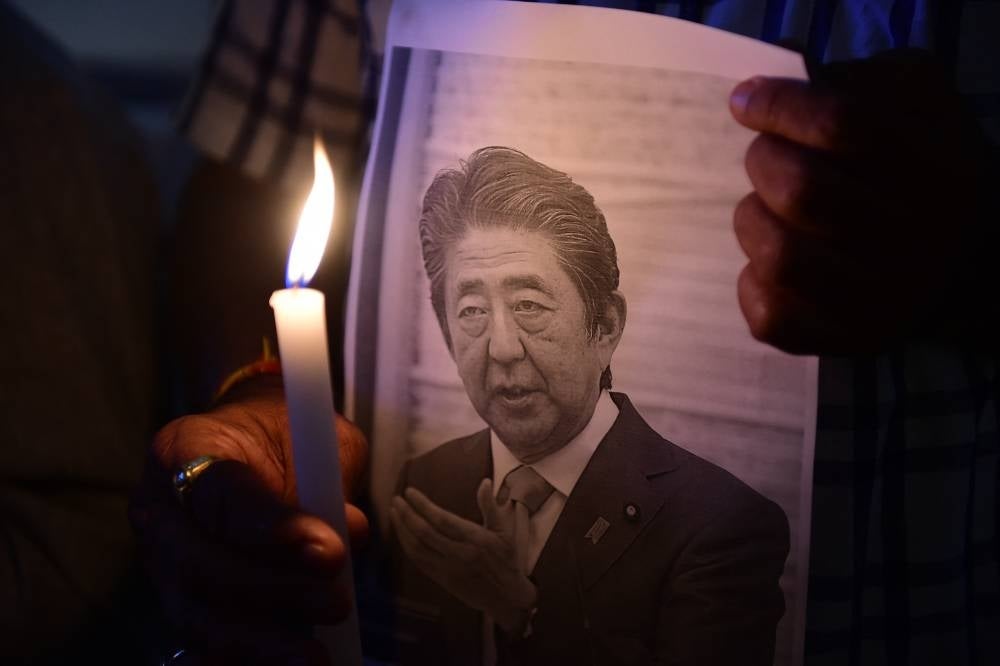 Members of the Japan information and study centre hold a candlelight vigil to pay tribute to the late former prime minister of Japan Shinzo Abe at Ahmedabad Management Association in Ahmedabad on July 9. Photo by Sam Panthaky/AFP