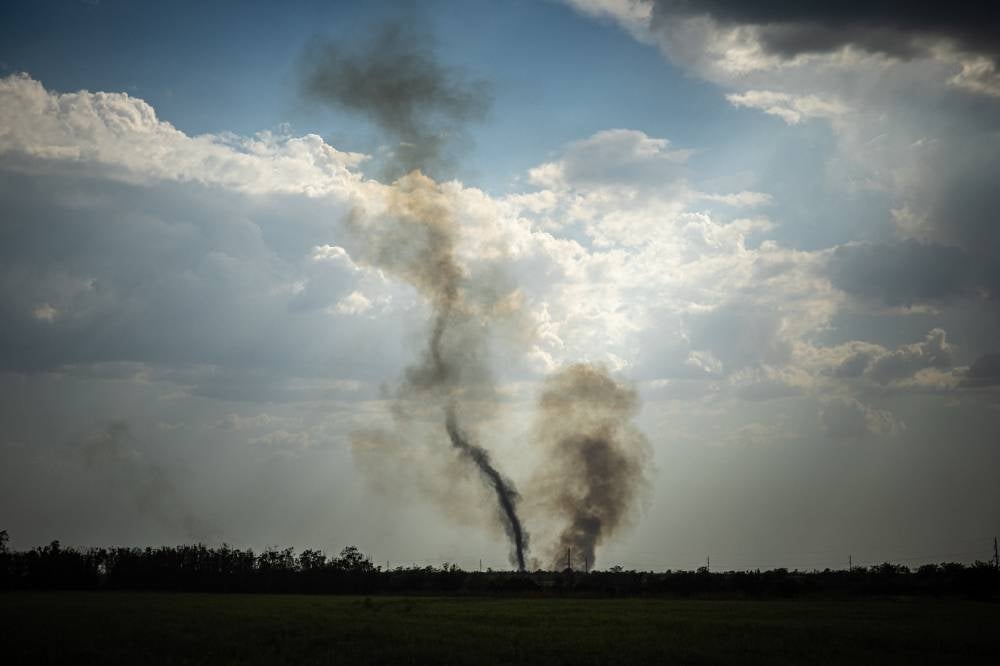 Black smoke rises at the front line in Mykolaiv Oblast on Aug 30, 2022, amid Russia's military invasion launched on Ukraine . - (Photo by DIMITAR DILKOFF / AFP)
