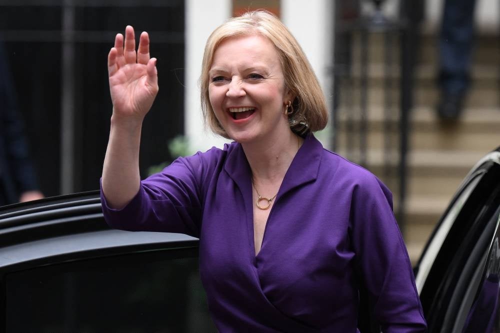 New Conservative Party leader and incoming prime minister Liz Truss smiles and waves as she arrives at Conservative Party Headquarters in central London having been announced the winner of the Conservative Party leadership contest at an event in central London on Sept 5, 2022. (Photo by Daniel LEAL / AFP)