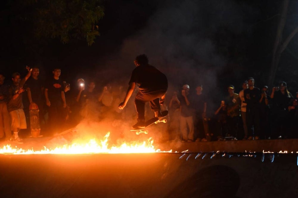 A skateboarder impressing judges and visitors with his daredevil and jaw-dropping moves, leaving spectators in awe.