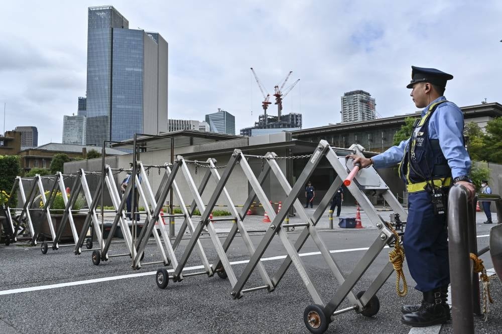 Police stand guard at the entrance to the prime minister's official residence in Tokyo on Sept 21, 2022. - (Photo by Richard A. Brooks / AFP)