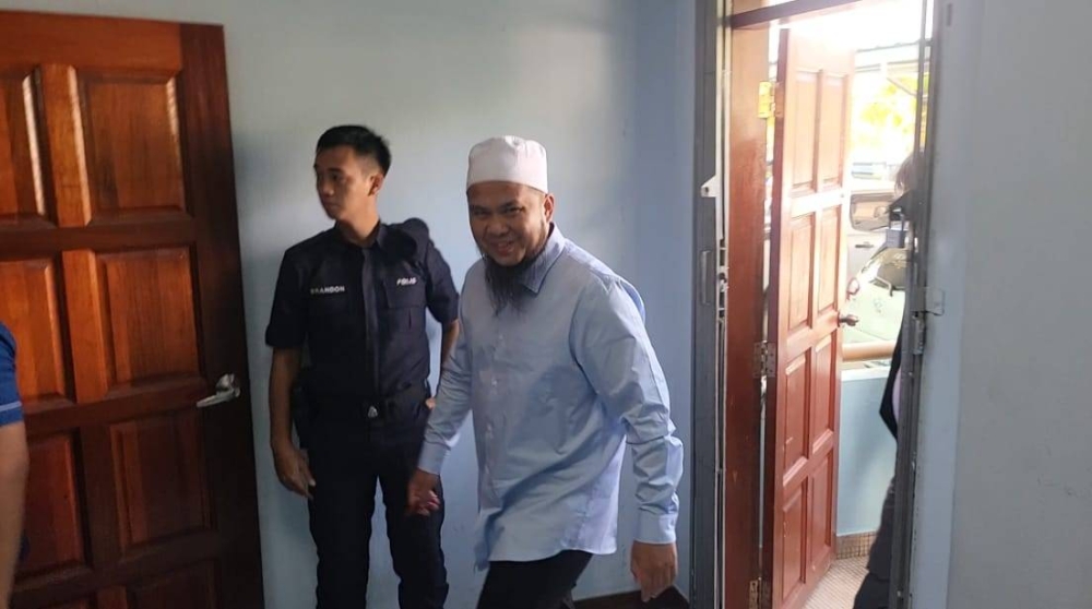 Lew arrives at the Tenom magistrate's court for his trial.