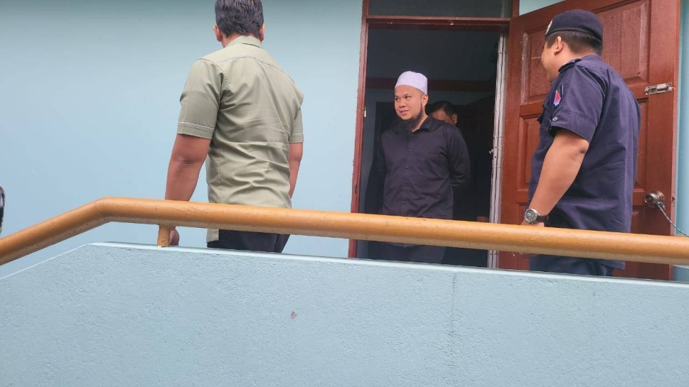 Ebit Lew at the Tenom magistrate's court for his trial.