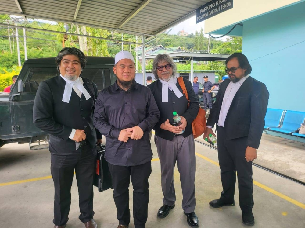 Preacher Ebit Lew (second from the left) at Tenom magistrate's court.