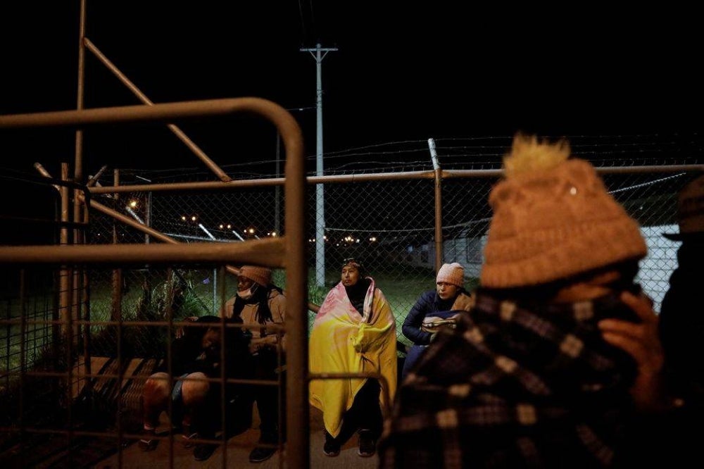 Family members of inmates wait outside the Cotopaxi No 1 penitentiary for news on their loved ones, in Latacunga, Ecuador October 3, 2022. (REUTERS/Karen Toro)