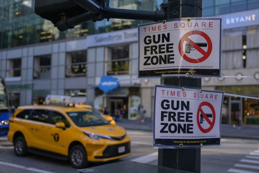 A "Gun Free Zone" sign is seen posted near Times Square in Manhattan on Sept 1, 2022 in New York. New York. - (Photo by ANGELA WEISS / AFP)