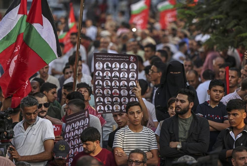 Palestinian supporters of the Popular Front for the Liberation of Palestine (PLFP) hold a rally in Gaza City on Oct 8, 2022 in support of hunger-striking Palestinian prisoners in Israeli jails. (Photo by Mahmud HAMS / AFP)