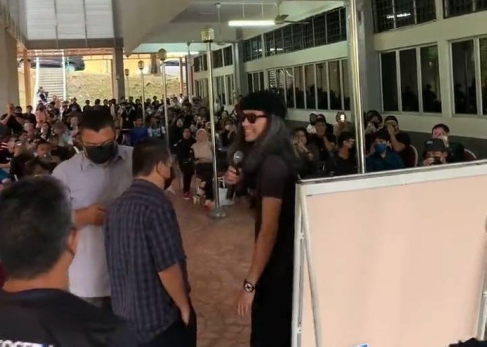 UiTM security stops Fahmi's (right) forum at UiTM Shah Alam on Friday