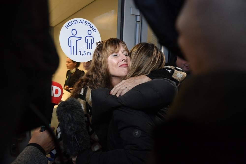 Victims' relatives embrace amid the trial of the MH17 downing case at the Schiphol Airport Judicial complex in Badhoevedorp on Nov 17, 2022. - (Photo by JOHN THYS / AFP)
