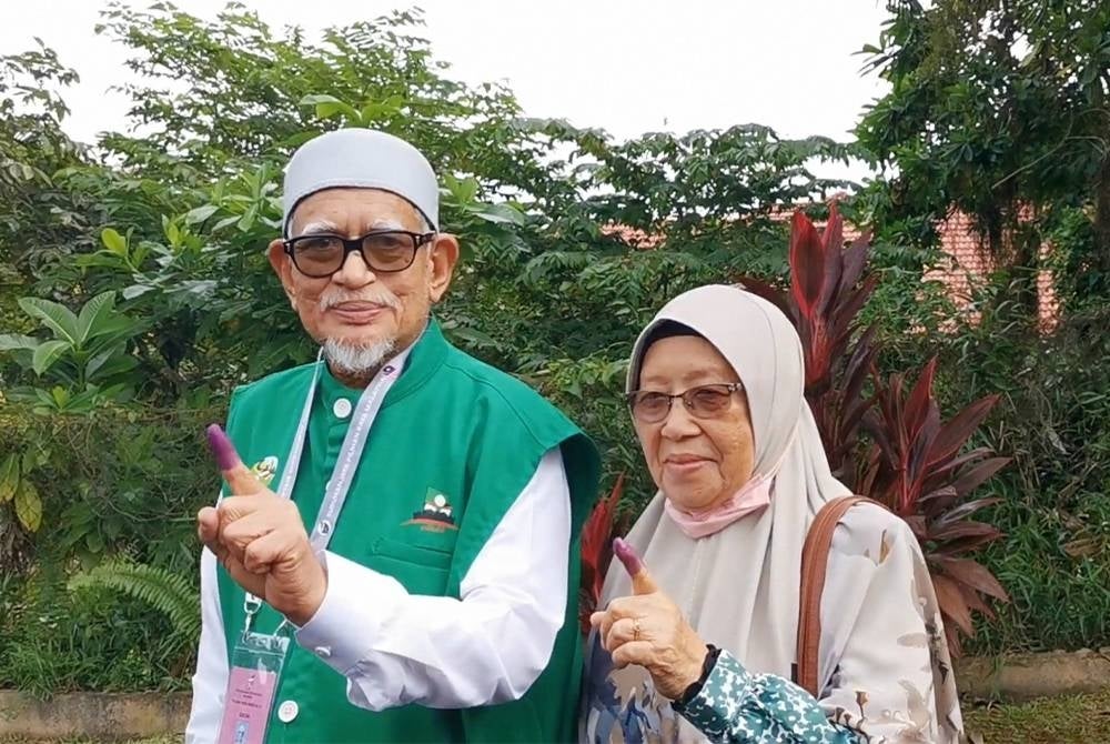 Abdul Hadi (left) and his wife Zainab successfully casted their votes in the polling centre at SK Rusila, Marang, Terengganu, on Saturday.