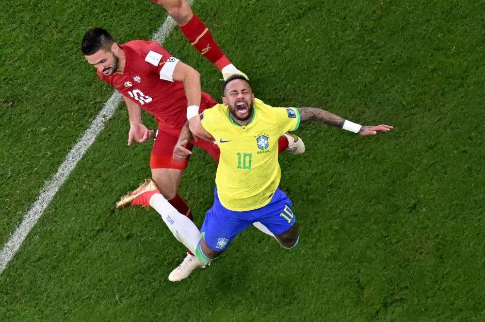 Brazil's forward #10 Neymar gestures after being fouled during the Qatar 2022 World Cup Group G football match between Brazil and Serbia at the Lusail Stadium in Lusail, north of Doha on November 24, 2022. Photo by Jewel Samad/AFP)
