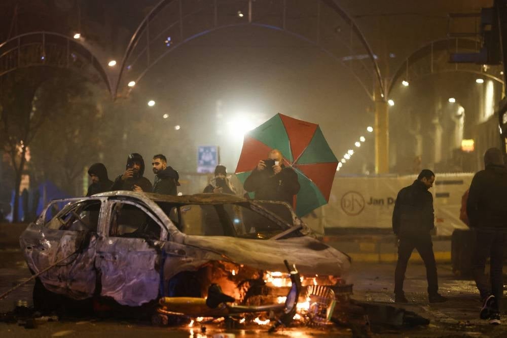 Violence broke out in Brussels on Nov 27, 2022, after Morocco's victory over Belgium at the World Cup, with "dozens of people" attacking street furniture and police, police said. (Photo by KENZO TRIBOUILLARD / AFP)