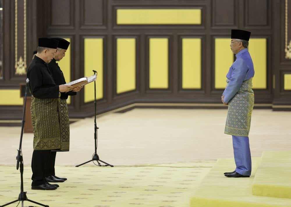 Datuk Seri Dr Ahmad Zahid Hamidi and Datuk Seri Fadillah Yusof take oath before the Yang di-Pertuan Agong Al-Sultan Abdullah Ri'ayatuddin Al-Mustafa Billah Shah at the palace today. Photo - BERNAMA
