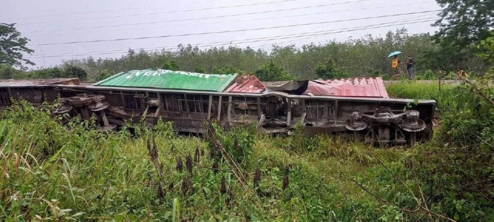 The damaged and derailed train of the State Railway of Thailand that skidded following its bombing near the Khlong Ngae Train Station in Sadao, Thailand. The cargo train was en route from Hatyai to Padang Besar.