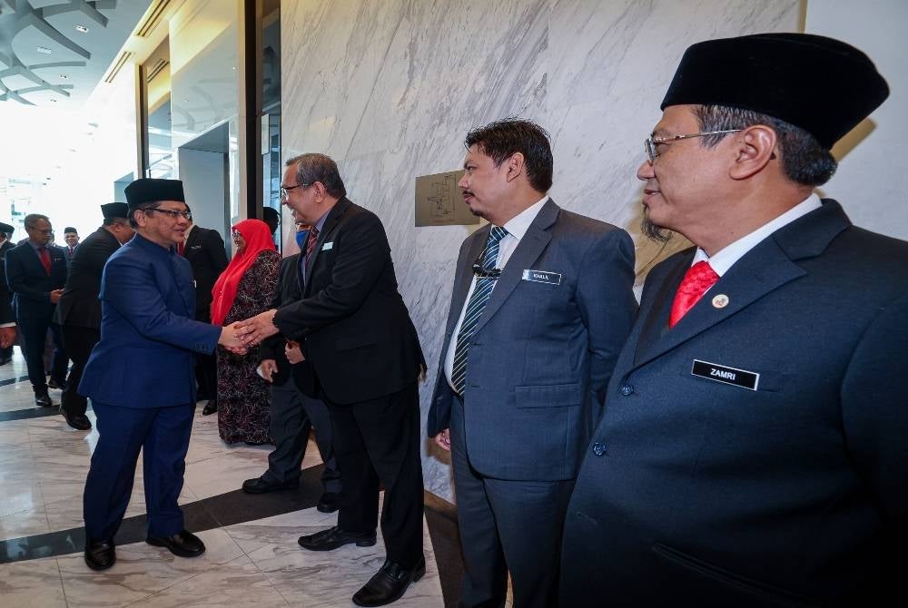 Religious Affairs Minister Datuk Dr Mohd Na'im Mokhtar (left) - BERNAMA
