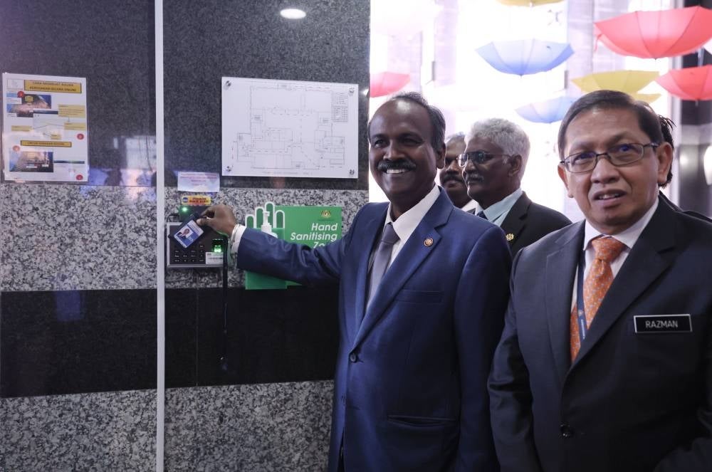 Human Resources Minister V. Sivakumar clocking in on his first day at the ministry.