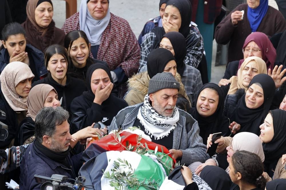 Palestinian mourners attend the funeral of 16-year-old Jana Zakarnaa, who was killed during an Israeli raid in the occupied West Bank, on Dec 12, 2022 in the city of Jenin. - (Photo by JAAFAR ASHTIYEH / AFP)