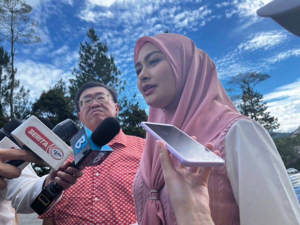 Bentong MP Young Syefura at the landslide site talking to reporters.
