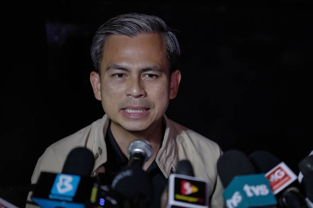 Fahmi Fadzil talking to the media during his visit at the landslide location in Batang Kali at the Father's Organic Farm. Photo by BERNAMA. 