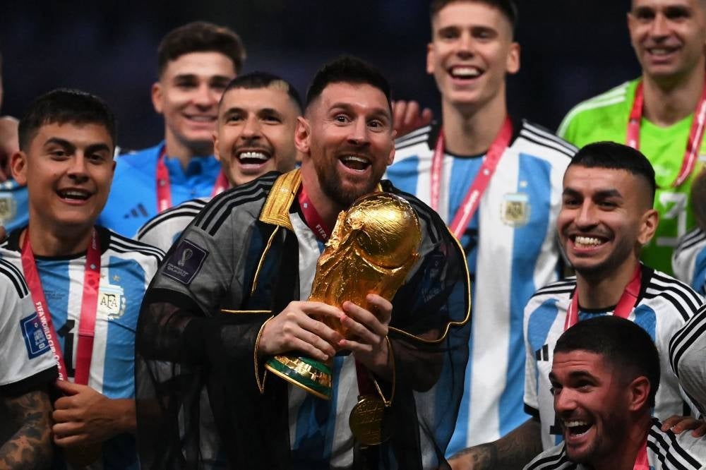 Argentina's forward #10 Lionel Messi lifts the World Cup trophy during the Qatar 2022 World Cup trophy ceremony after the football final match between Argentina and France at Lusail Stadium in Lusail, north of Doha on December 18, 2022. (Photo by FRANCK FIFE / AFP)