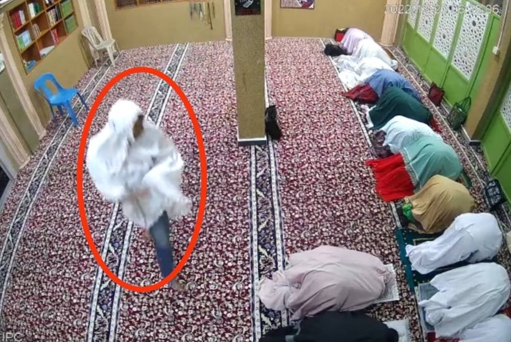 CCTV recording showing the suspect wearing a white telekung stealing valuables from the women's prayer area.