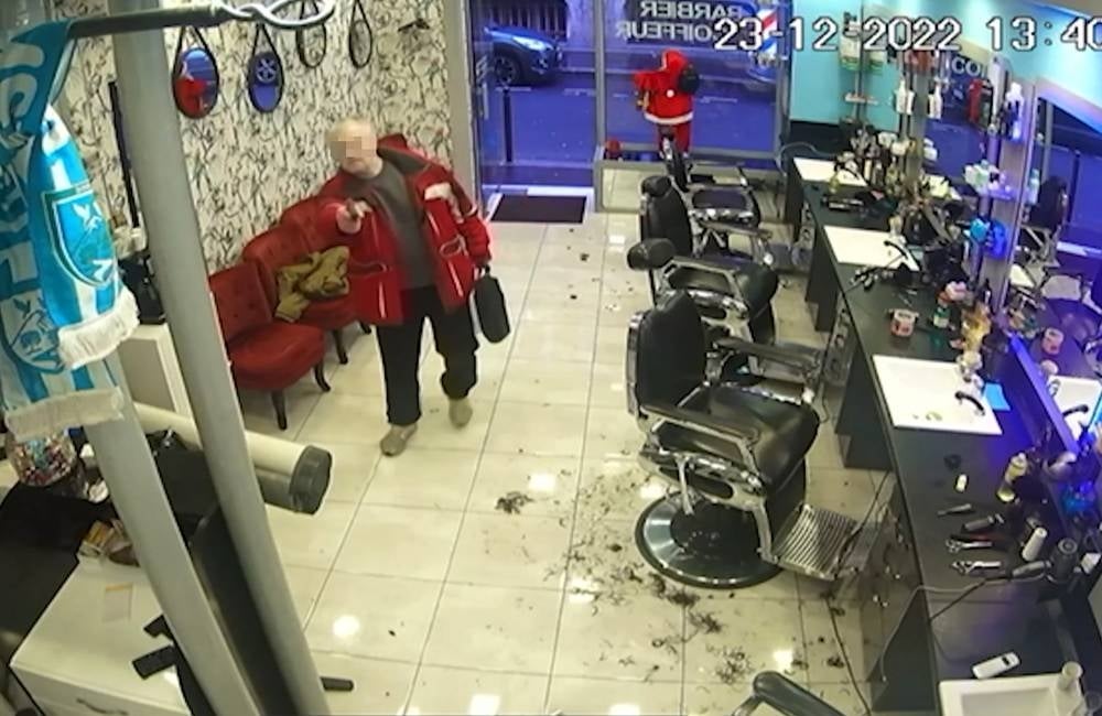 A screengrab showing a 69-year-old French gunman entering a hairdressing salon on Dec 23, 2022 after he fired shots outside the Centre Ahmet Kaya "Centre democratique du Kurdistan" (Kurdistan democratic centre) in Paris, killing three people and wounded others. - AFP