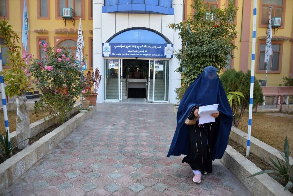 A female university student walks in front of a university in Kandahar Province on Dec 21, 2022. - Afghanistan's Taliban rulers banned university education for women nationwide, provoking condemnation from the US and UN over another assault on human rights. - AFP