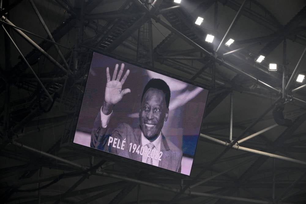 A photograph of Brazilian football legend Pele displayed on a giant screen prior to the French L1 football match between Olympique de Marseille and Toulouse FC at the Velodrome stadium in Marseille on Dec 29, 2022. - (Photo by NICOLAS TUCAT / AFP)