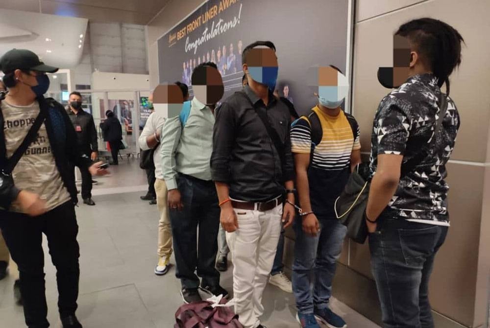 Six Indian migrants who were detained by immigration officers in a special operation at KLIA2, Sepang last November - FILE PIX