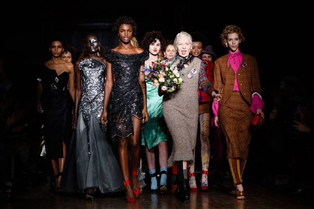In this file photo taken on Feb 21, 2016 British designer Vivienne Westwood (4th R) stands with models during the finale of her catwalk show at the Autumn / Winter 2016 London Fashion Week in London. (Photo by LEON NEAL / AFP)