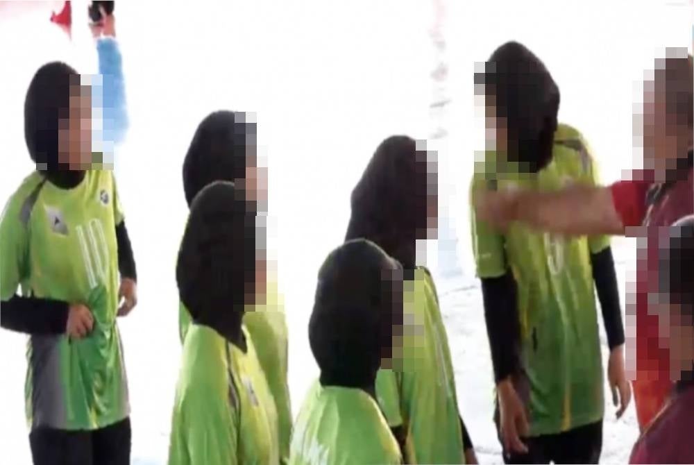 A screenshot of the video where a volleyball coach allegedly slapped two of his players.