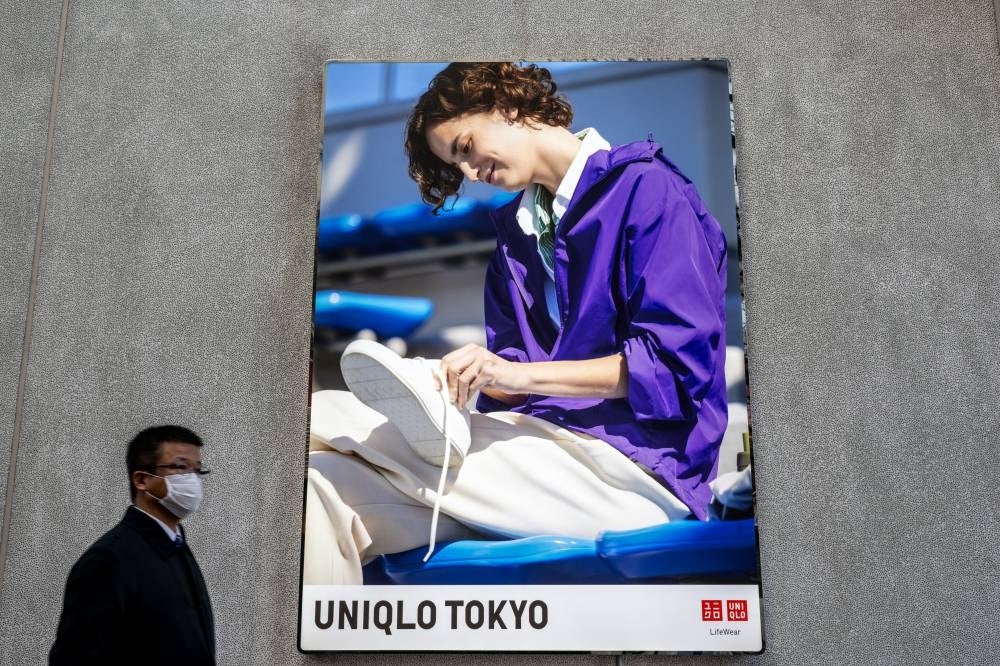 Fast Retailing, the parent company of clothing giant Uniqlo, said its net profit for the first quarter slid 9.1 per cent because of China's Covid lockdowns. - (Photo by PHILIP FONG / AFP)