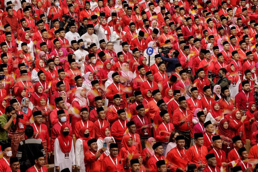Umno members singing 'Bersatu, Bersetia, Berkhidmat' at the Umno General Assembly at Putra World Trade Centre, Kuala Lumpur, here. Photo by Bernama.