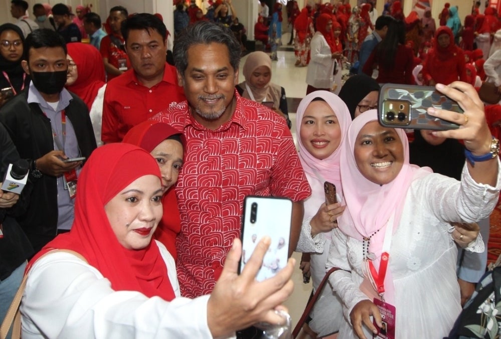 Umno Wanita and Puteri delegates taking a selfie with Khairy during on the second day of the assembly,
