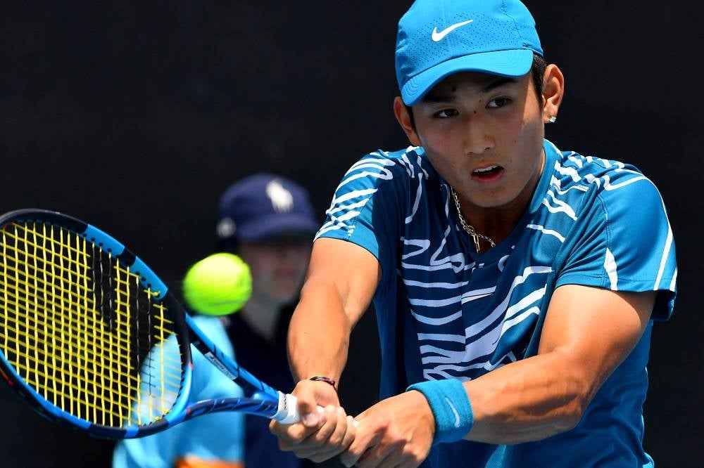China's Shang Juncheng hits a return against Germany's Oscar Otte during their men's singles match on day one of the Australian Open tennis tournament in Melbourne on Jan 16. (Photo by Paul CROCK / AFP)