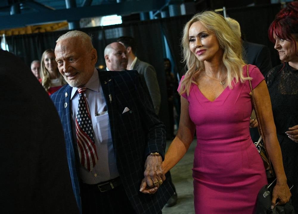 Former Nasa astronaut Buzz Aldrin arrives with (then) girlfriend Anca Faur on July 17, 2019, for an Apollo 11 anniversary celebration dinner at the Davidson Centre for Space Exploration at the US Space & Rocket Centre in Huntsville, Alabama. - (Photo by LOREN ELLIOTT / AFP)