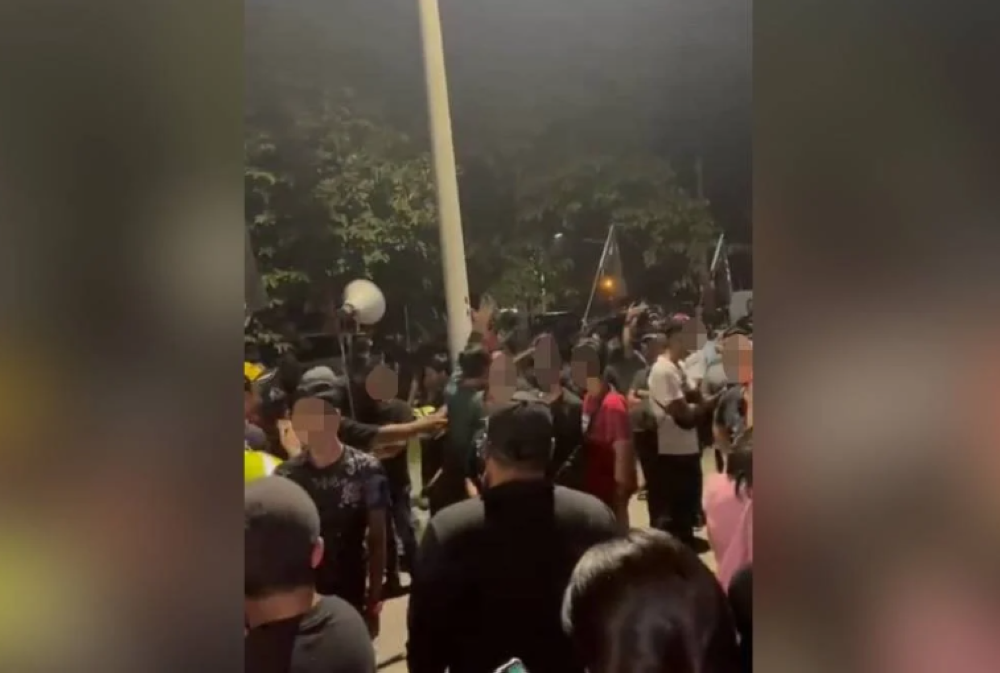 A group of men causing disturbance at Syed Saddiq's in Muar last October.