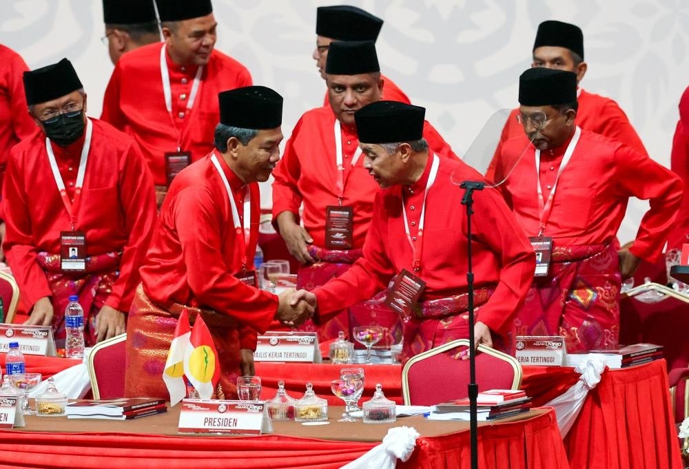 Umno Deputy President Datuk Seri Mohamad Hasan greets President Datuk Seri Ahmad Zahimi after giving his speech on Jan 13 during the Umno General Assembly at World Trade Centre. (Photo by BERNAMA) 