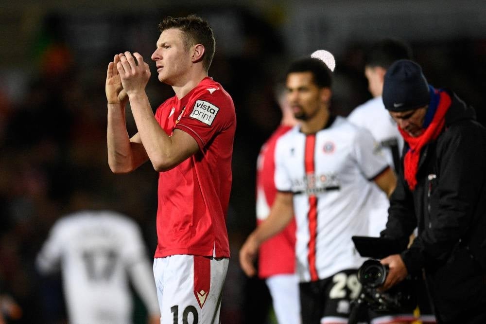 Wrexham's English striker Paul Mullin applauds the fans following the English FA Cup fourth round football match between Wrexham and Sheffield United at the Racecourse Ground Stadium in Wrexham, north Wales, on Jan 29.. - The match ended in a draw at 3-3. - AFP