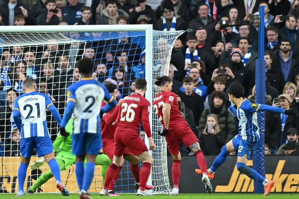 Brighton's Japanese midfielder Kaoru Mitoma (R) scores their second goal during the English FA Cup fourth round football match between Brighton & Hove Albion and Liverpool at the Amex stadium in Brighton, on the south coast of England on Jan 29. - AFP