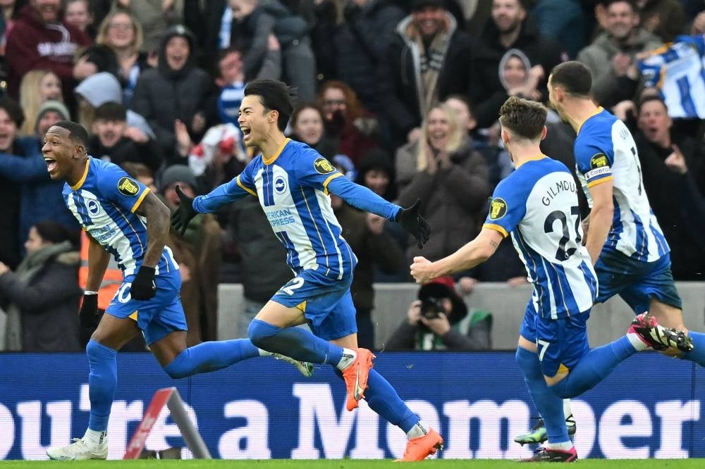 Brighton's Japanese midfielder Kaoru Mitoma (C) celebrates with teammates after scoring their second goal during the English FA Cup fourth round football match between Brighton & Hove Albion and Liverpool at the Amex stadium in Brighton, on the south coast of England on Jan 29. - Brighton won the game 2-1. - AFP