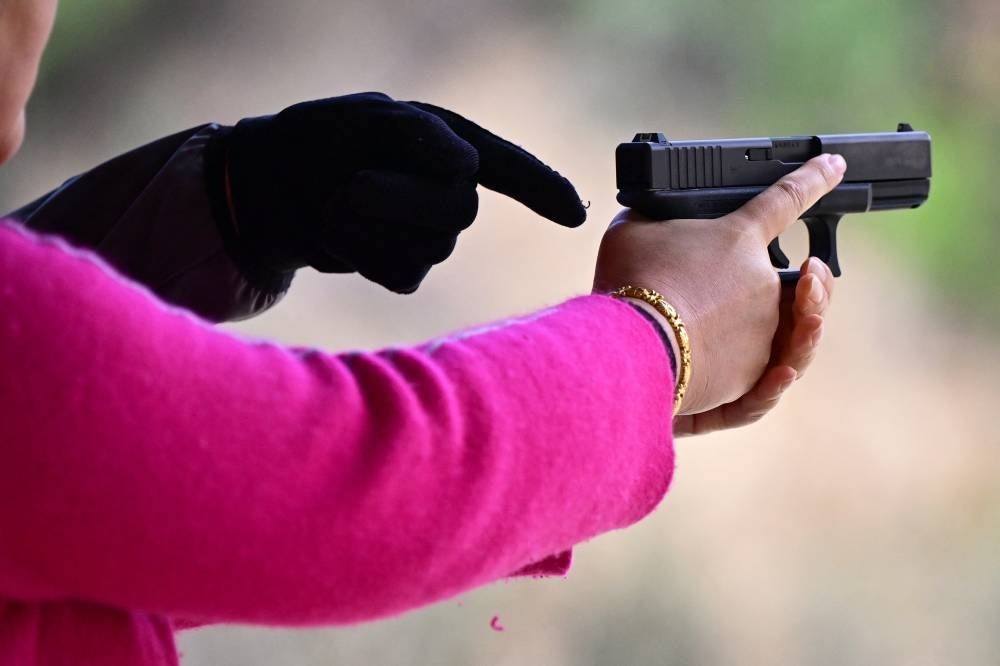 A student learns how to fire a weapon during Defensive Pistol Class at Burro Canyon Shooting Park in Azusa, California on Feb 12, 2023. - (Photo by FREDERIC J. BROWN / AFP)