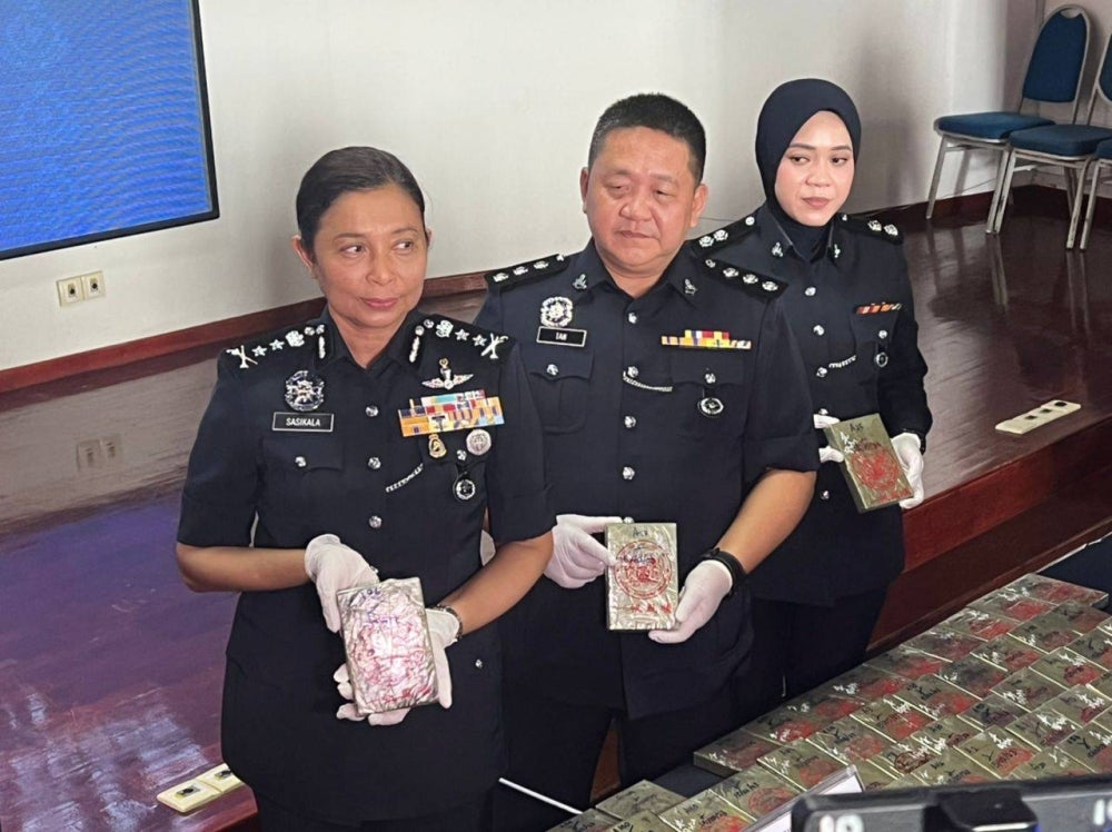 Acting Selangor Police Chief S Sasikala Devi (left) with her officers after a raid 