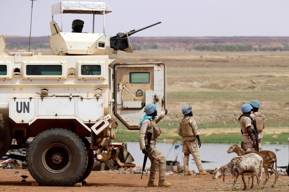In this file photo taken on July 24, 2019 Senegalese soldiers under the UN peacekeeping mission in Mali MINUSMA (United Nations Multidimensional Integrated Stabilisation Mission in Mali) dismount an armoured personnel carrier, patrolling in the streets of Gao, a day after suicide bombers in a vehicle painted with UN markings injured one French, several Estonian troops and two Malian civilians in an attack on an international peace-keeping base in Mali. Three United Nations peacekeepers were killed and five were seriously injured on February 21, 2023 when their convoy struck a roadside bomb in central Mali, the UN mission said. - AFP