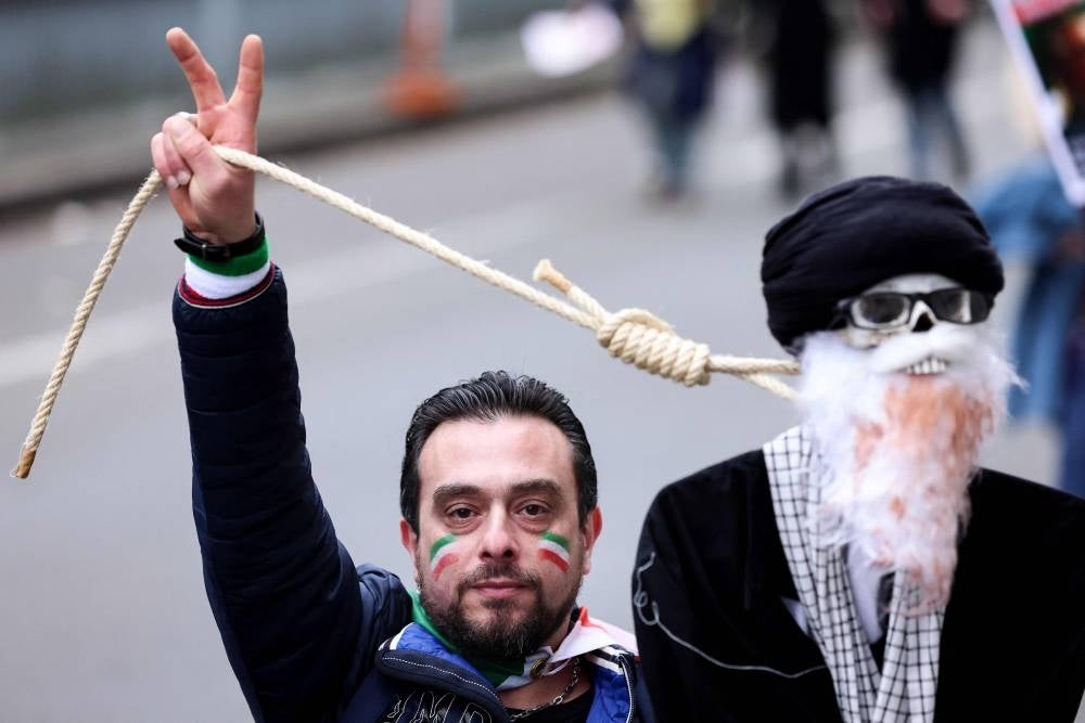 A demonstrator holds a hanging doll representing Iran's Supreme Leader during a protest supporting Iranian resistance movement in Brussels on Feb 20. - AFP