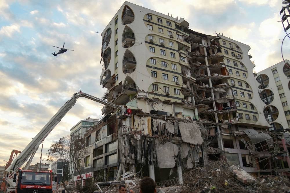 A crane demolishing a damaged building thought to contain several animals in Diyarbakir, south-eastern Turkey, as animal-friendly people asked authorities to intervene and rescue the trapped animals, following the deadly earthquakes that ravaged southern Turkey. - (Photo by ILYAS AKENGIN / AFP)