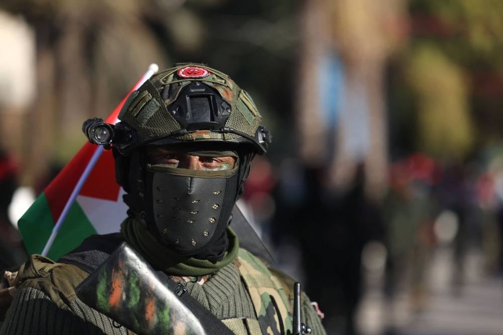 A masked Palestinian militant of the Democratic Front for the Liberation of Palestine, takes part in a march to denounce the killing of Palestinians by the Israeli army in Nablus and to support Palestinians in Israeli jails, in Gaza City, on Feb 22, 2023. - (Photo by MOHAMMED ABED / AFP)