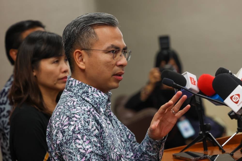 Communications and Digital Minister Fahmi Fadzil speaks during a press conference after visiting the media centre at the Parliament Building today. - BERNAMA